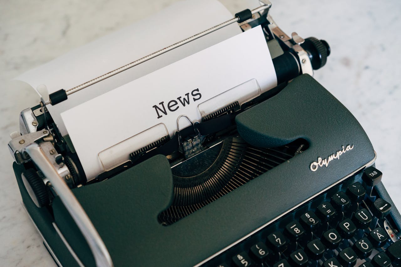 Close-up of an antique typewriter with News on paper.